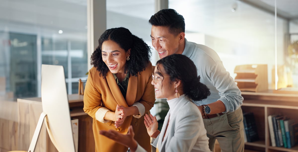 Ecommerce team reviewing product content on a monitor